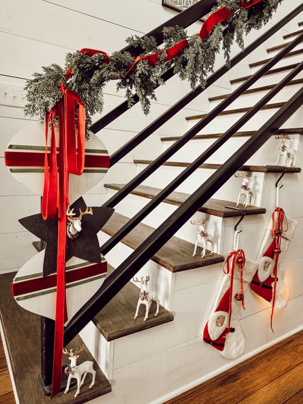 Banister with DIY Large Ornaments and DIY Reindeer from Dollar Tree Transformed into High-end Christmas Decor.