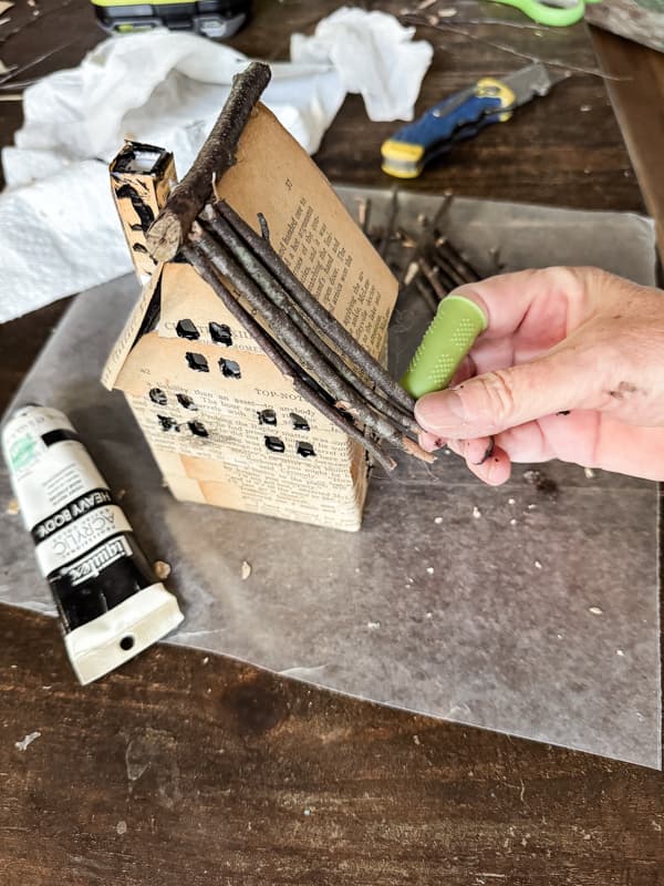 Add twigs to roofs of DIY Christmas Village Display