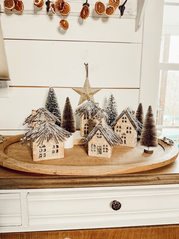 DIY Upcycled Old Book Page Christmas Village with inexpensive ceramic mini-houses.