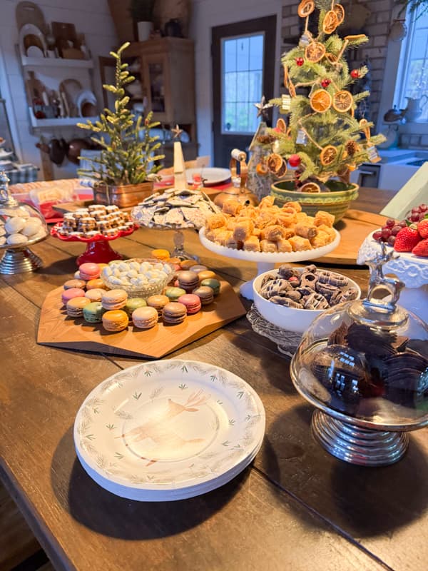 Dessert Charcuterie Board For Christmas Party with cake plates filled with fruit and candy.