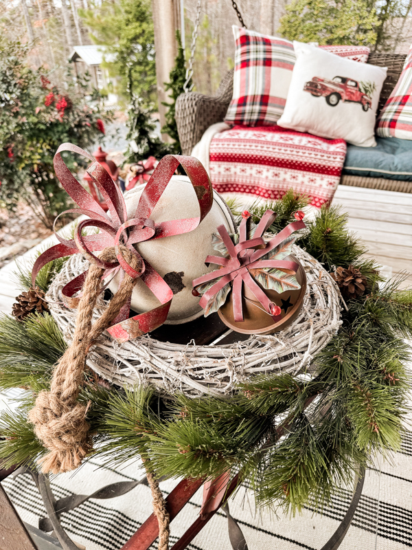 Vintage sled with thrifted wreaths and jingle bells for a coffee table centerpiece on Christmas Farmhouse porch.