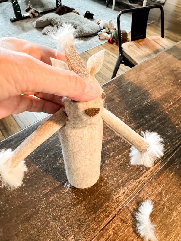 Add fur yarn to trim your DIY Toilet Paper Roll Reindeer.