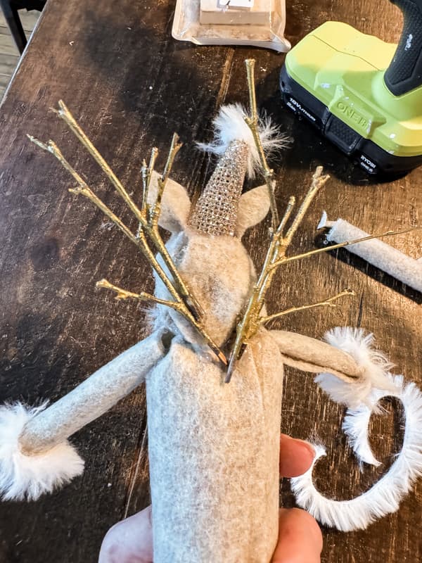 Used gathered twigs painted gold for add antlers to the recycled reindeer.
