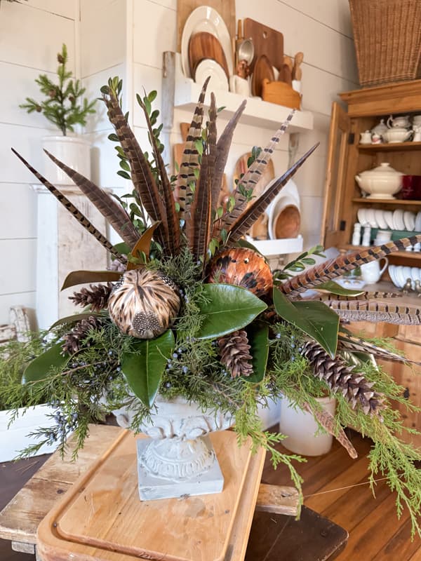 Christmas Centerpiece Ideas with rustic-chic pheasant feathers and feather ornaments plus foraged pinecones.