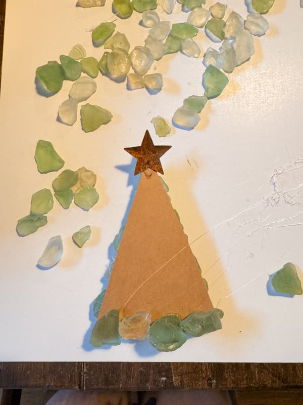 Add metal star to back of cardboard tree shape and attach sea glass to it with hot glue.