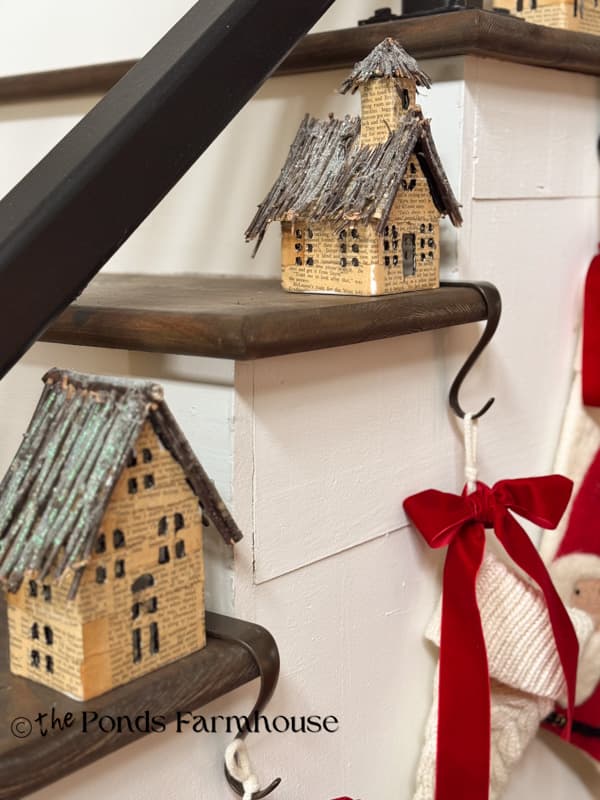 Upcycled Old Book Page Christmas Village on stair steps with stockings