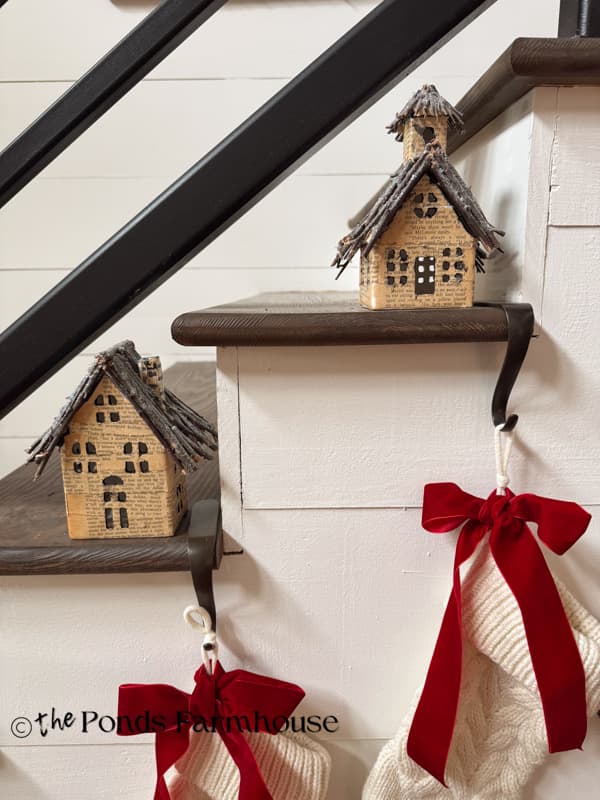 Upcycled Old Book Page Christmas Village on stair steps with stockings