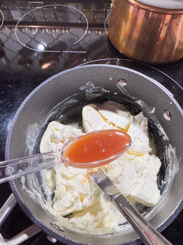 cream cheese in sauce pan with tabasco sauce