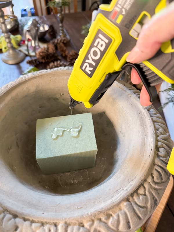 Add styrofoam to the bottom of a container to make a floral arrangement.