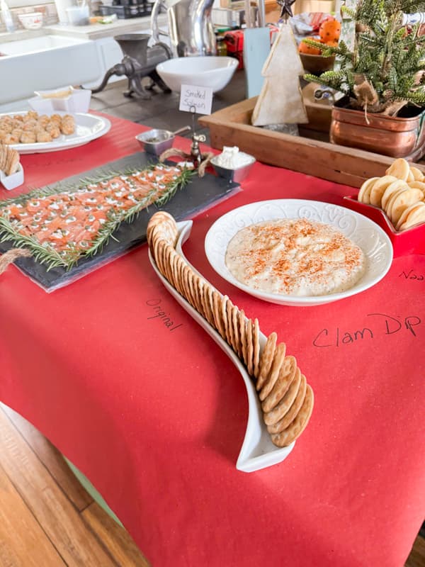 Cover seafood charcuterie board with red craft paper.