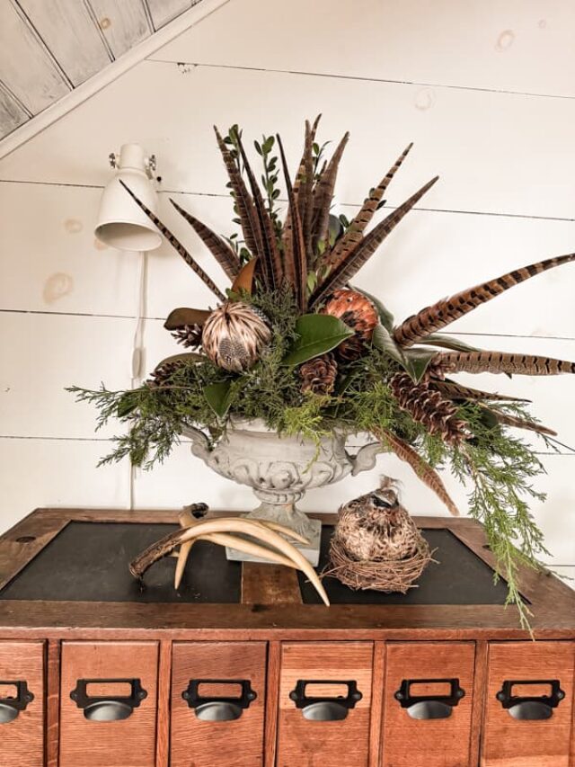 Rustic Chic Greenery and Pheasant feather centerpiece on wine bar. 