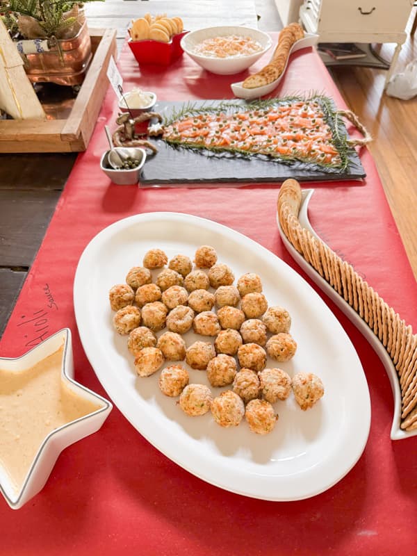 Crab Cakes with Aioli Sauce for a Seafood Charcuterie Board party Idea on red craft paper.  