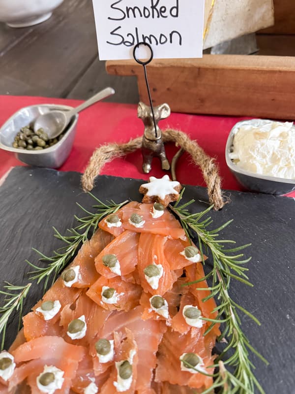 Christmas Charcuterie Board Ideas with smoked salmon shaped like a Christmas Tree, wrapped with rosemary.