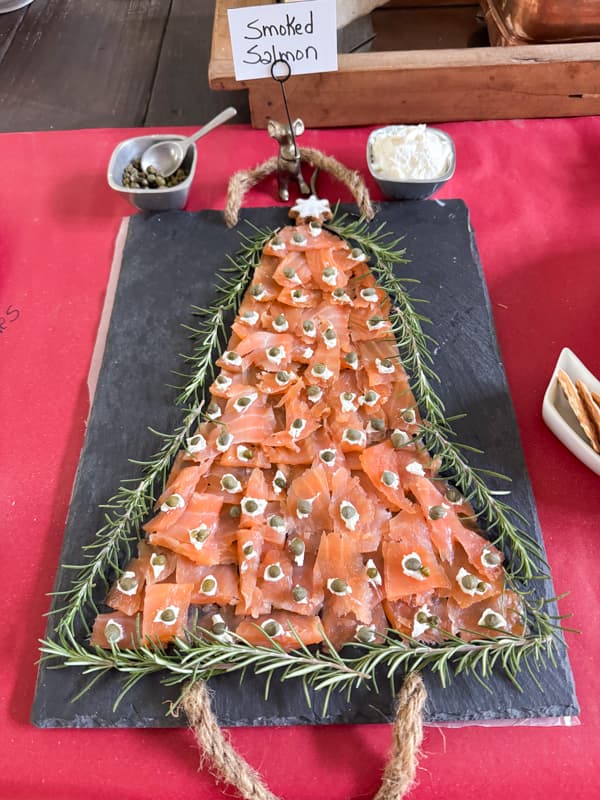 Christmas Charcuterie Board Ideas with smoked salmon shaped like a Christmas Tree, cream cheese and capers.