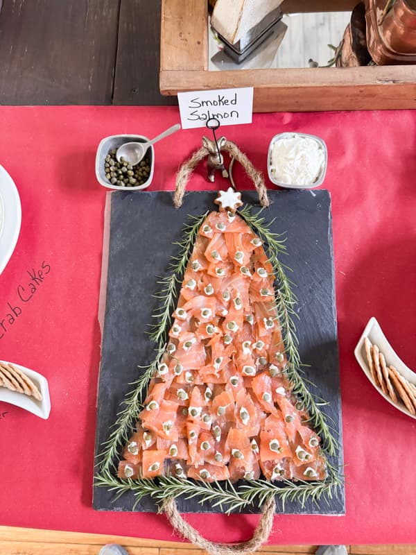 Christmas Charcuterie Board Ideas with smoked salmon shaped like a Christmas Tree, cream cheese and capers.