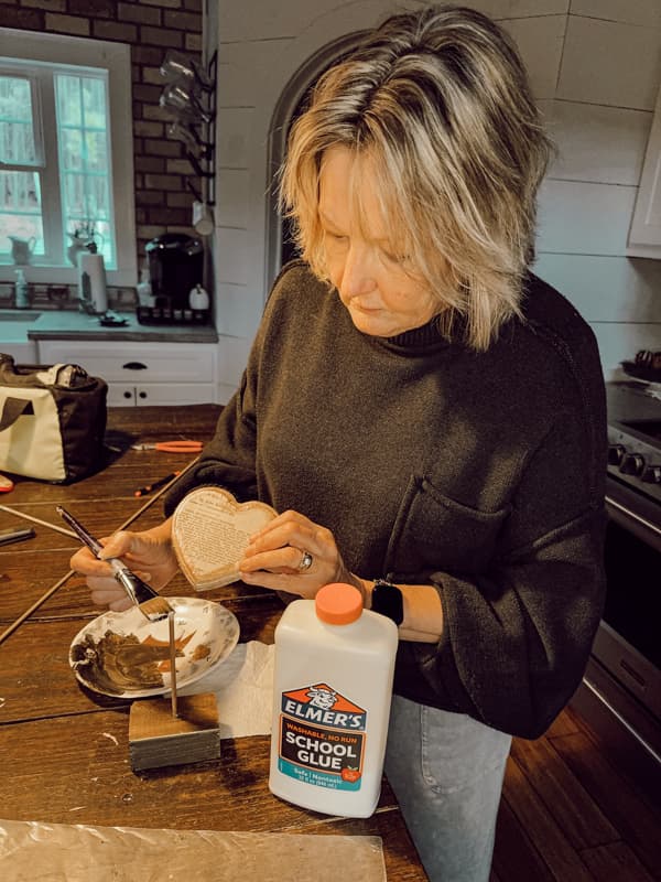 Add glue to attach wood heart to stand for rustic Valentine Decoration