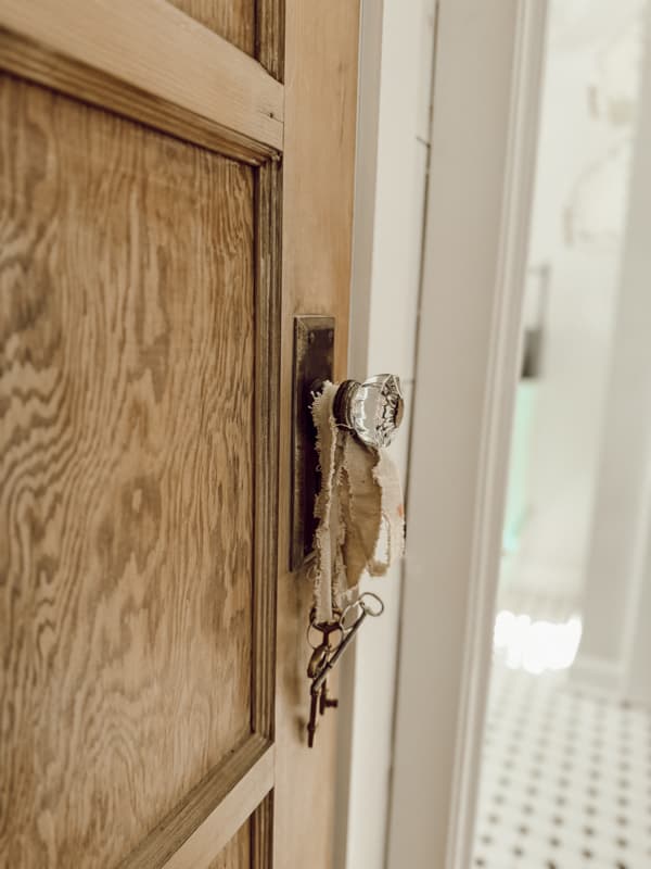 Antique Door Handle on vintage door of coat closet in country farmhouse.