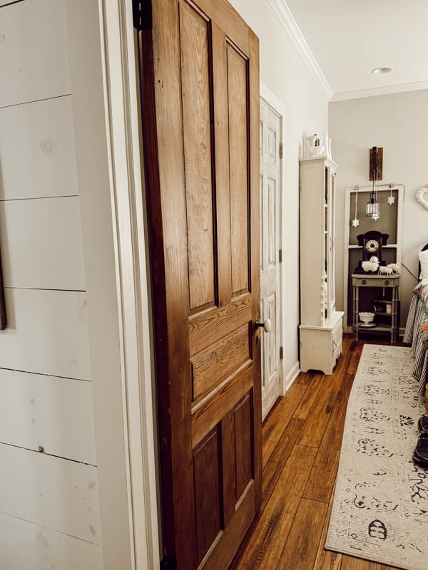 Vintage wood door in guest bedroom with old door knobs