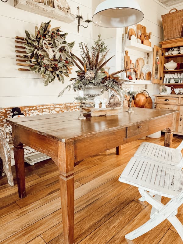 Antique Walnut Farm Table in modern farmhouse with chippy church pew and folding bench. 