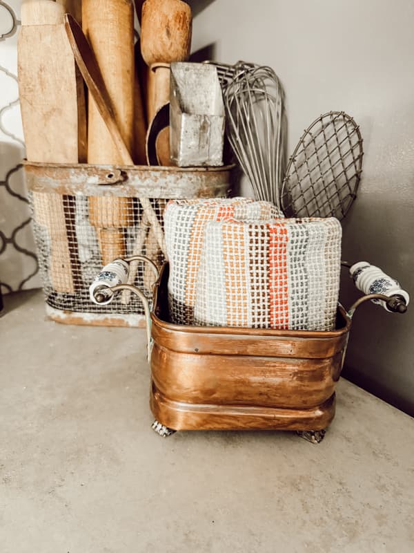 Copper containers for styling vintage and antique copper pieces.  Add folded kitchen towels to copper container 