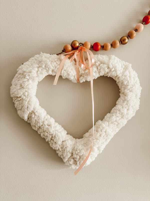 Deconstructed Dollar Tree Heart Frame covered with shepa fleece fabric for a Valentine Wreath 