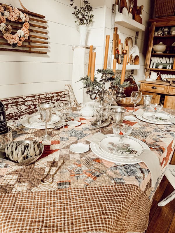 For antique decorating style add a antique quilt to a farmhouse style table for a cozy winter style. 