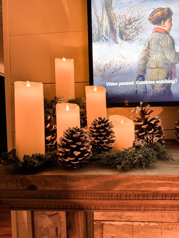 flicker candles with pinecones on a DIY Faux Fireplace mantel 