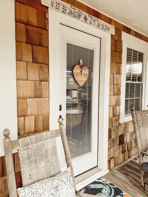 Tiny beach cottage with DIY Rustic Valentine's Wood Heart with Seashells on front door hanger.