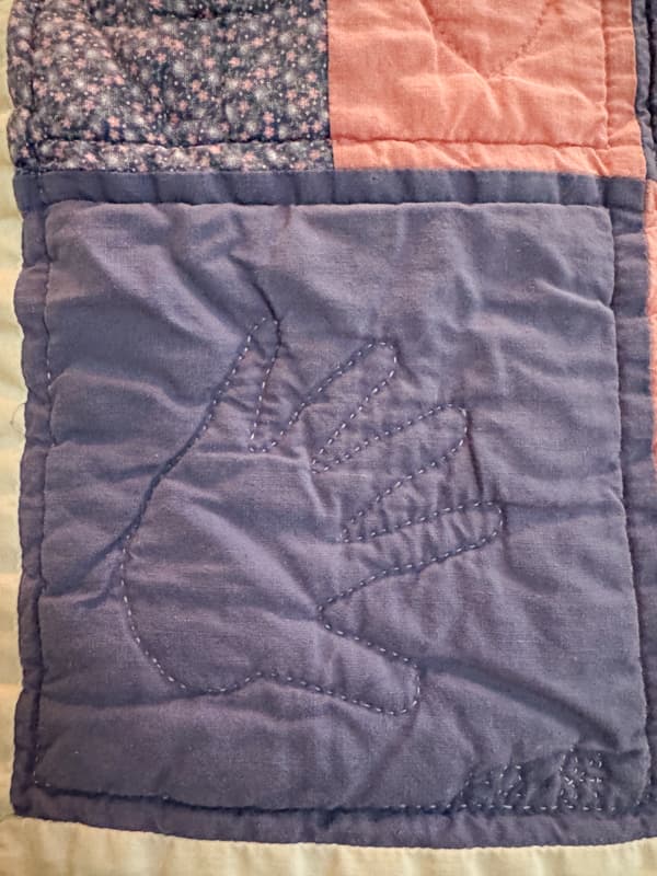 Daughters tiny hand traced and quilted into a lap quilt.  