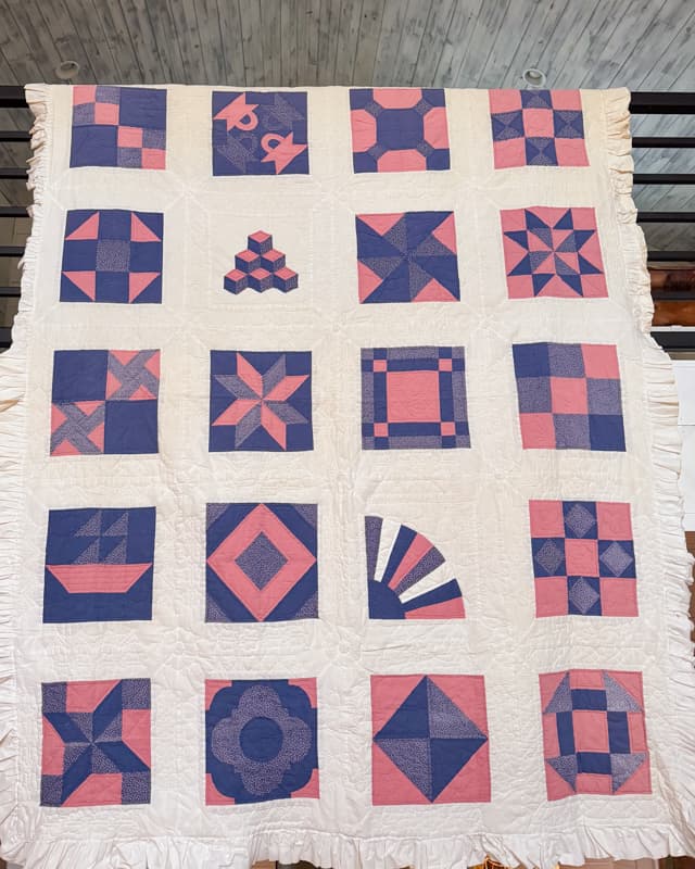 DIY lap quilt made in 1983 with pink and blue with white ruffle edge. 