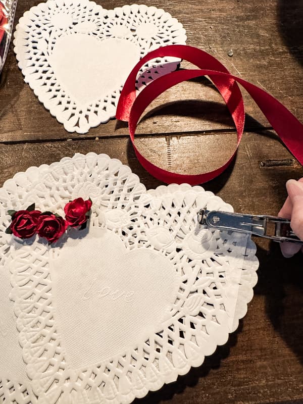 make a chair charm pocket with Dollar tree doilies and red ribbon.  