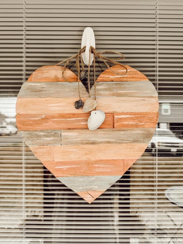 Primitive heart with seashells for a beach cottage cozy front door hanger.