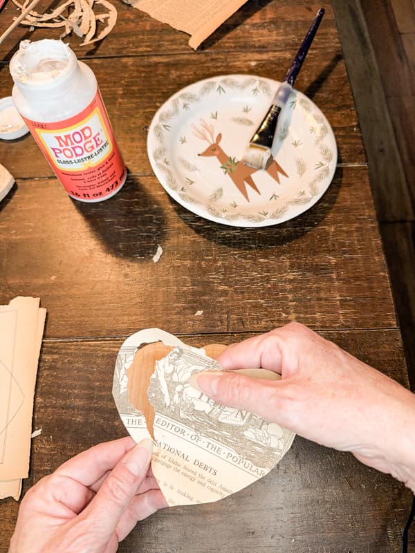 Tear paper hearts to apply to the wooden hearts for a rustic Valentine Decoration