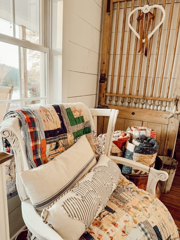 Drape a deconstructed chair with an antique quilt and add folk art pillows.  