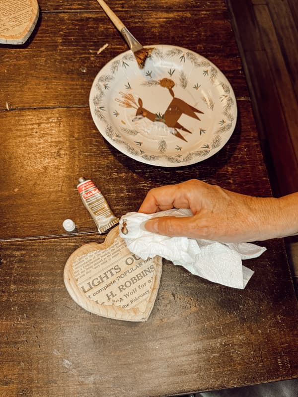 Add rub and buff antique gold to edges of the wooden hearts.  