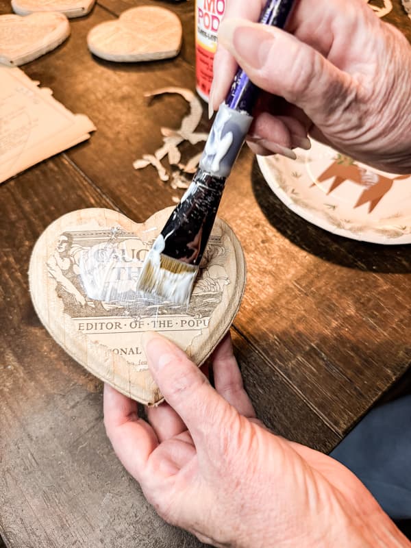 Cover old book pages with mod podge to decoupage the Vintage Valentine Rustic Valentine Decoration Idea.