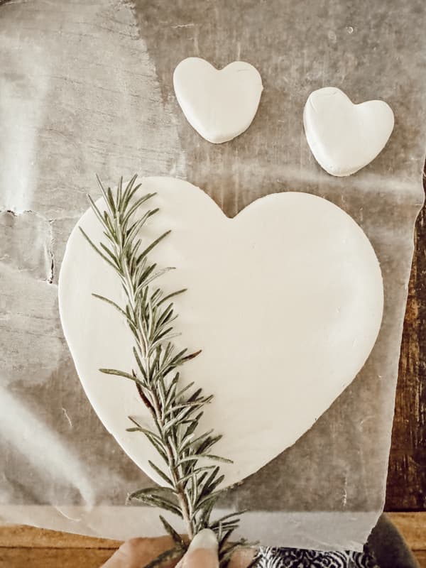 add design to clay hearts with rosemary sprig.  Cottagecore ideas.