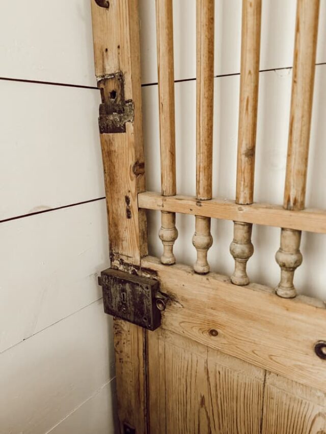 Antique Door and hardware on door used as decoration in industrial farmhouse.