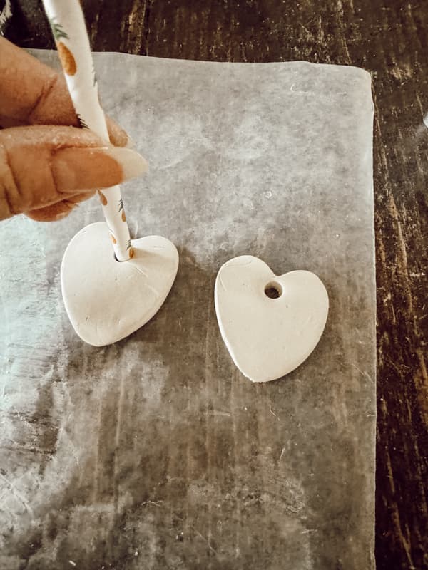 use straw to cut a hole in each air dry clay gift charms.  