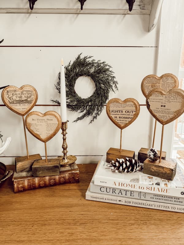 DIY Heart stands with books for risers and flicker candlestick on entry table.  Rustic Valentine Decor