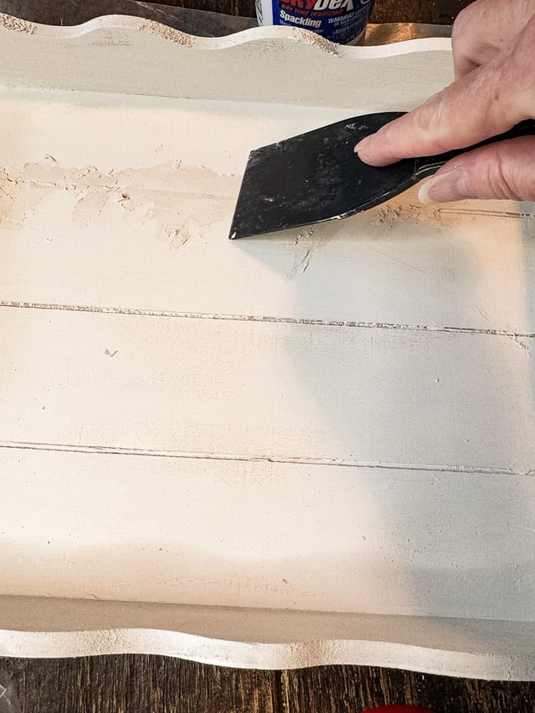 Fill grooves in wood with putty.