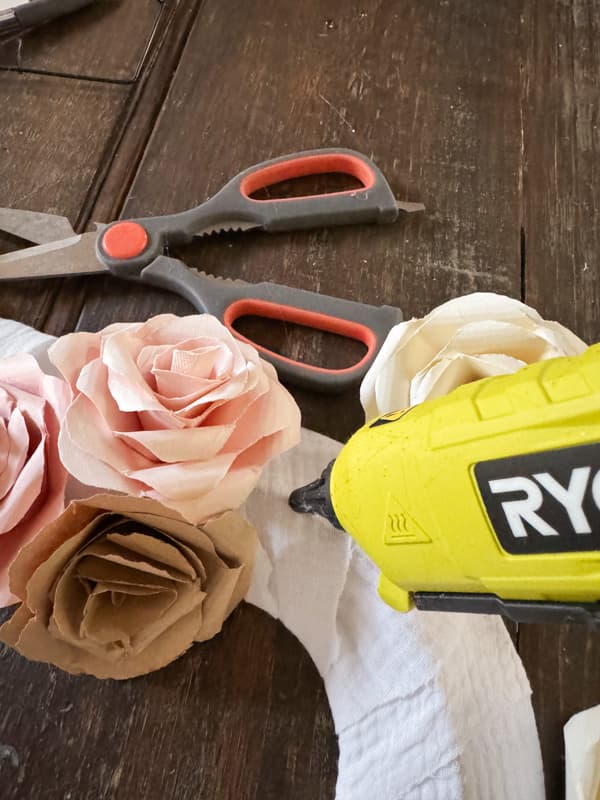 Hot glue paper roses to a Dollar Tree Heart Frame for a easy DIY Valentines' Day Craft. Cottagecore craft ideas.