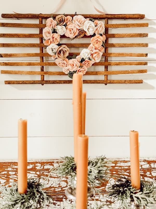 Inexpensive Dollar Tree Wreath with Paper Flowers for Valentine's Day Decorations over the dining table.