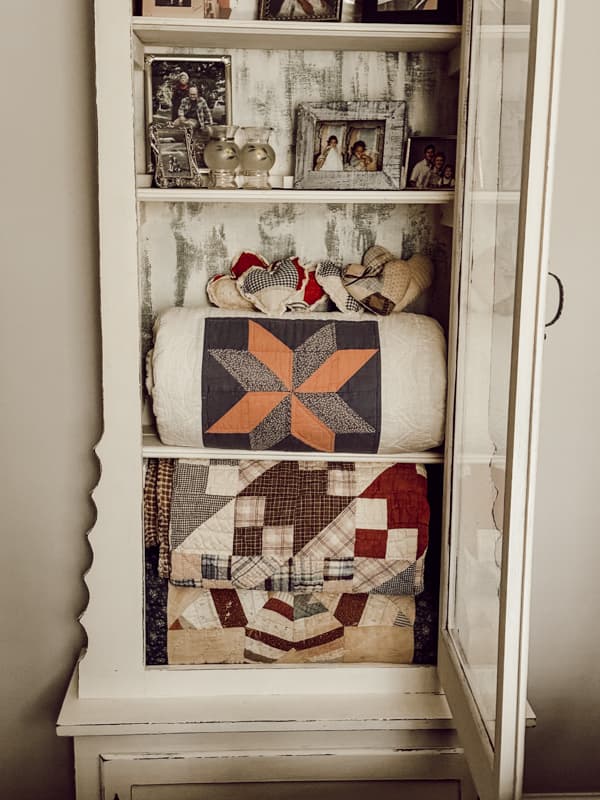 Antique and Vintage Quilts in Old Gun Cabinet.  Ways to Display old quilts.  