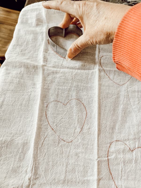 stamp hearts on flour sack tea towels for inexpensive handcrafted Gift Ideas.  