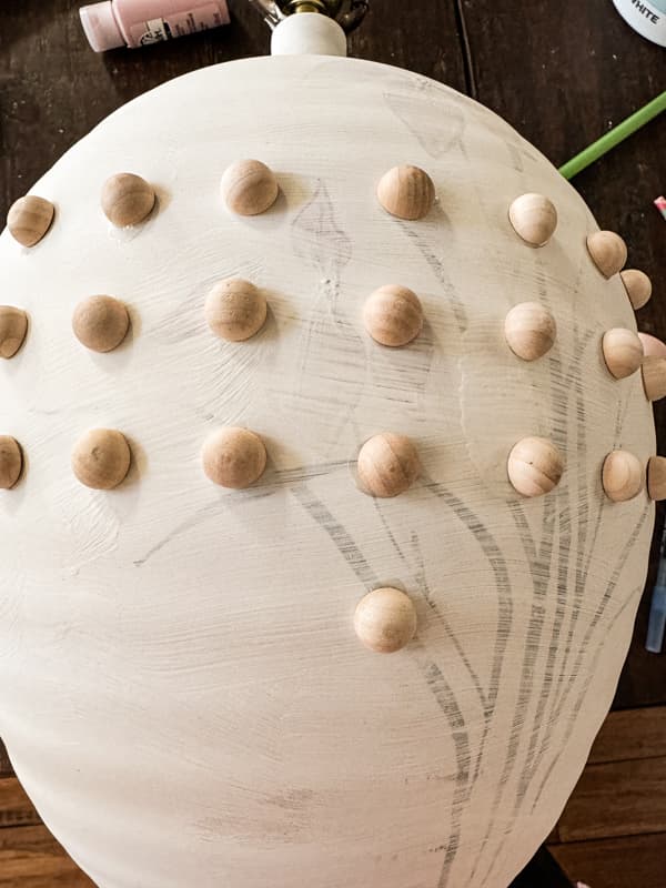 Add split wood balls to create a faux hobnail milk glass design on a thrift store lamp