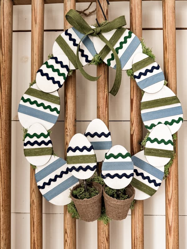 Painted Ribbon Blue and Green Easter Egg Wreath on Old Barn Door