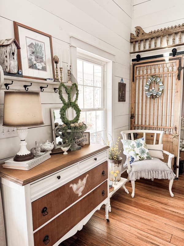 Entry area of farmhouse decorated for Spring with DIY Dollar Tree Wreath and Bunny topiary.  