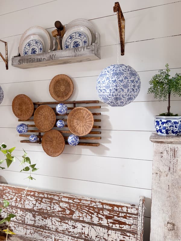 Chinese blue and white lantern with DIY Chinoiserie balls and woven basket plates for wall decor. 