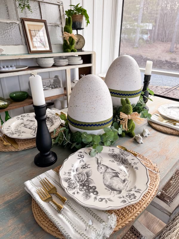 Porch dining table with DIY Speckled Large Easter Eggs: Dollar Tree Craft with black and white bunny dishes.